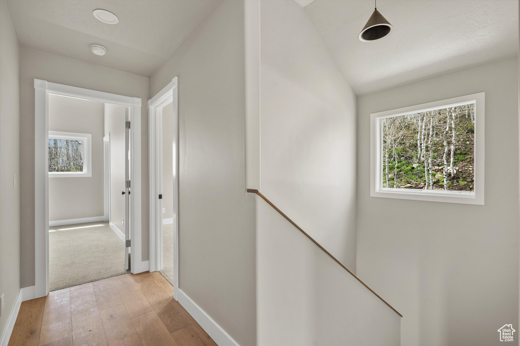 Hall featuring light wood-type flooring and baseboards