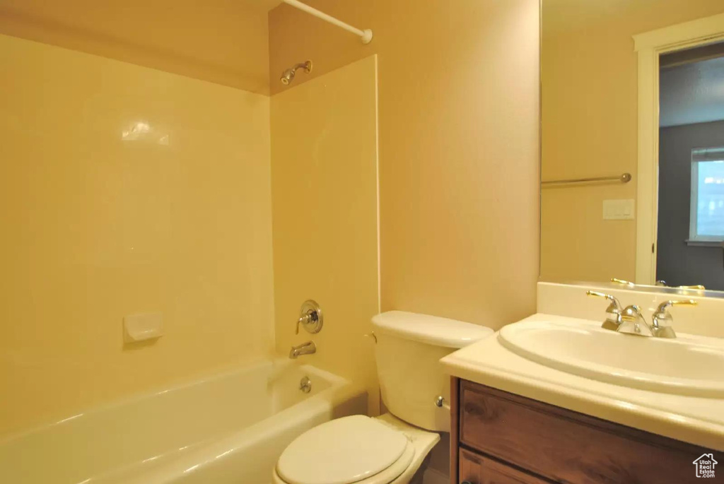 Full bathroom with toilet, vanity, and tub / shower combination