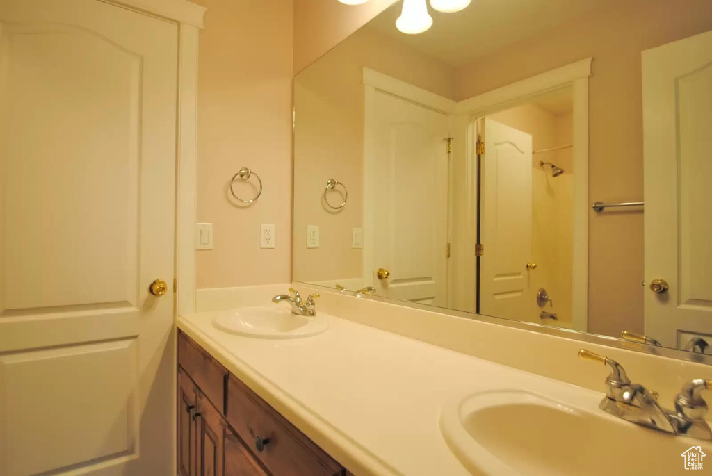 Full bathroom with double vanity and a shower