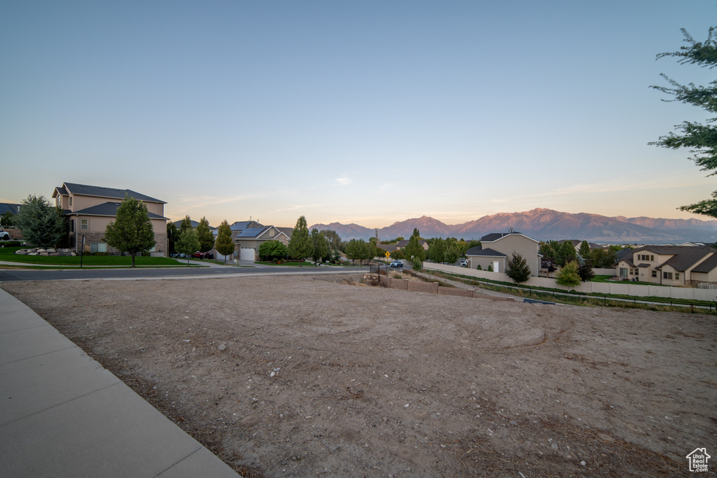 Yard at dusk with a mountain view and a residential view