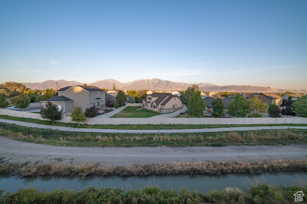 View of mountain backdrop with nearby suburban area and a large body of water
