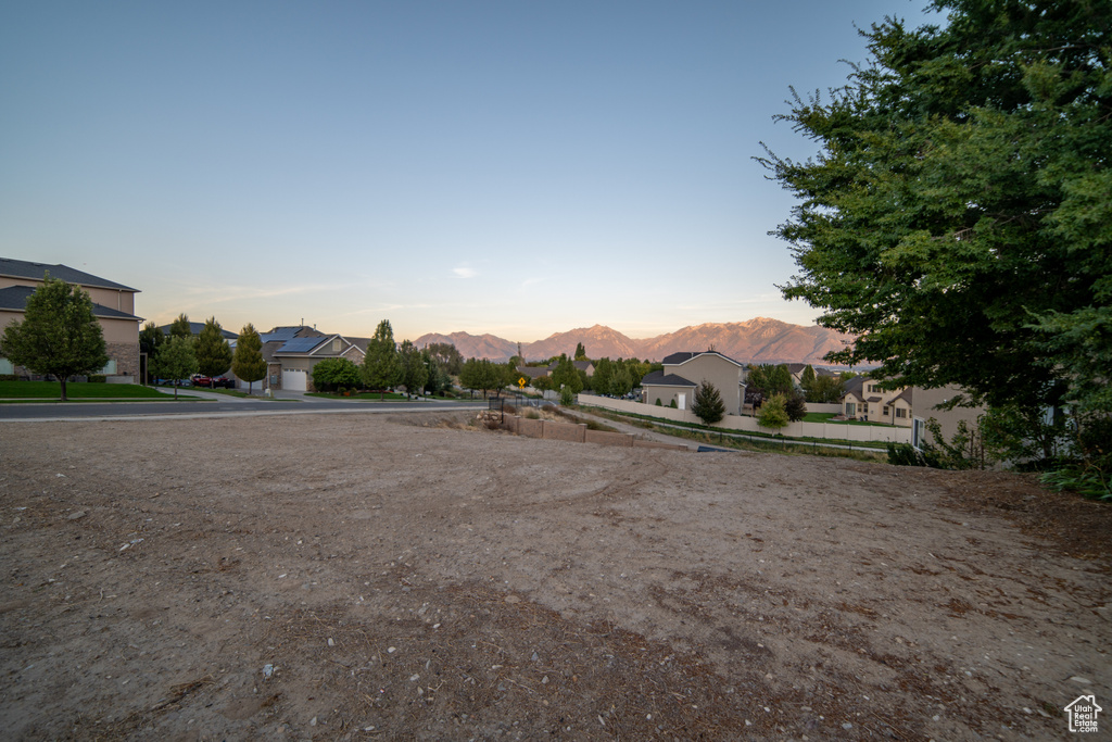 Yard at dusk with a mountain view and a residential view
