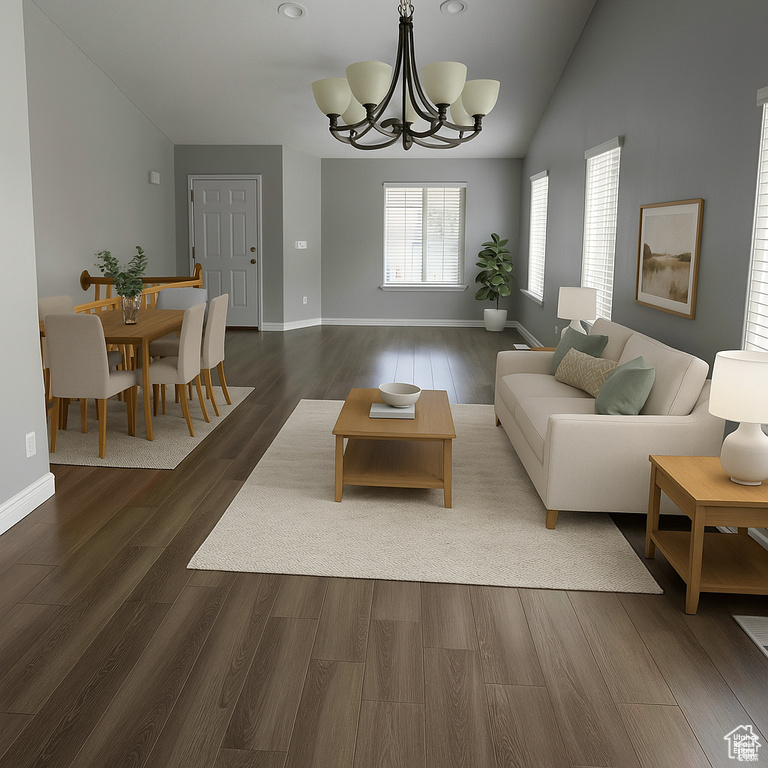 Living area with vaulted ceiling, a chandelier, dark wood-style floors, baseboards, and recessed lighting
