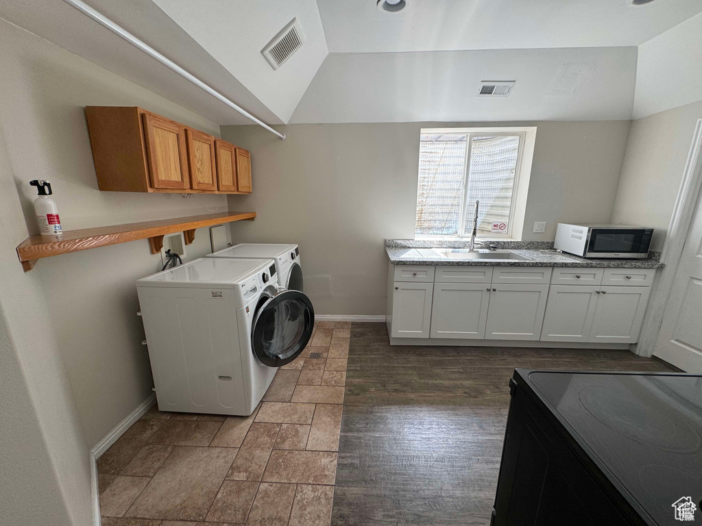 Laundry room with washer and dryer, baseboards, and cabinet space