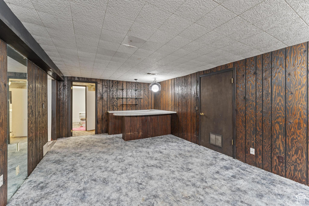 Bar area with carpet floors and wood walls