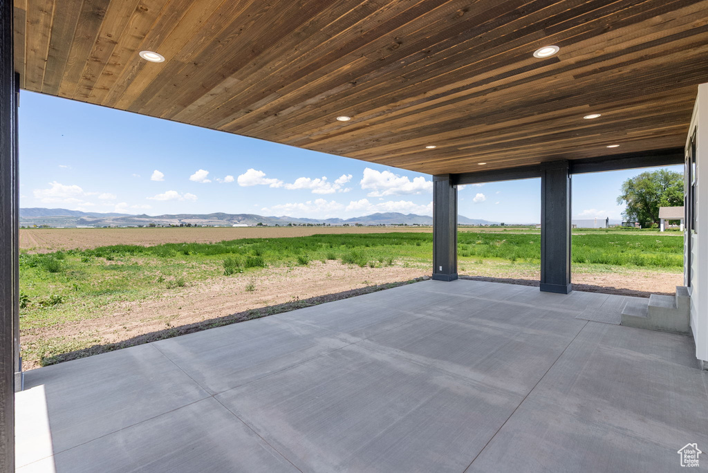 View of patio with a mountain view and a rural view
