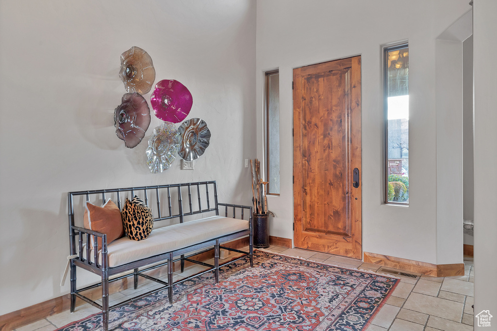 Tiled foyer featuring visible vents and baseboards