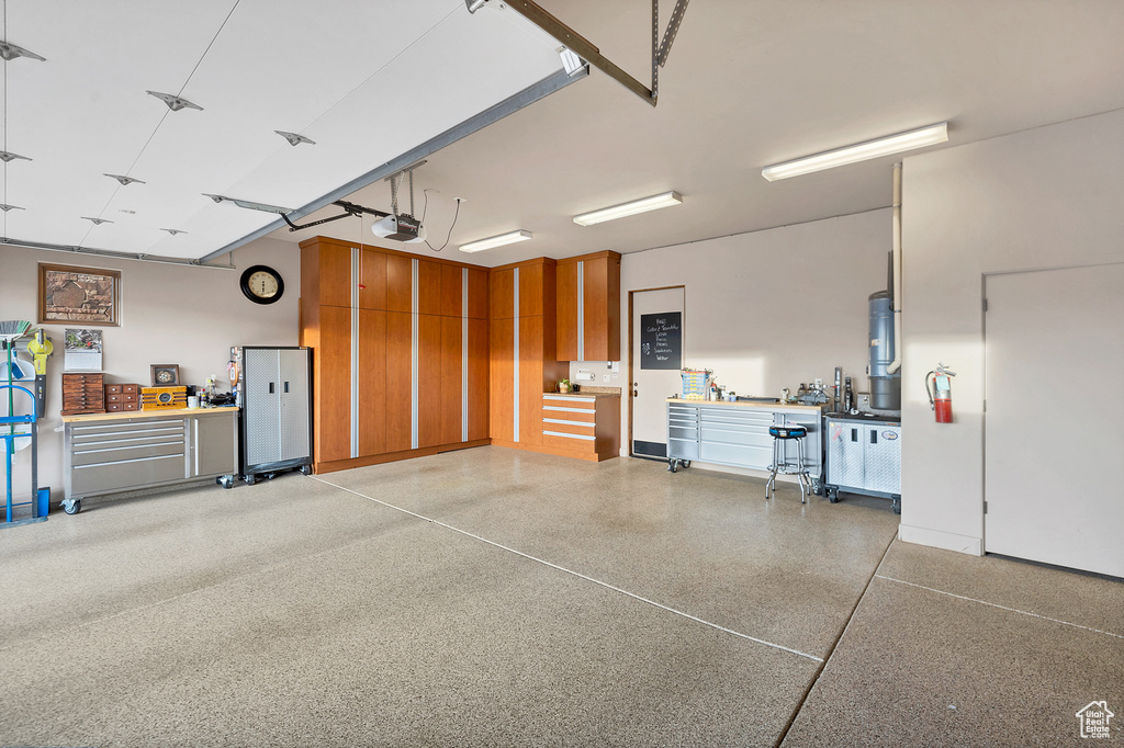 Garage with a workshop area and a garage door opener