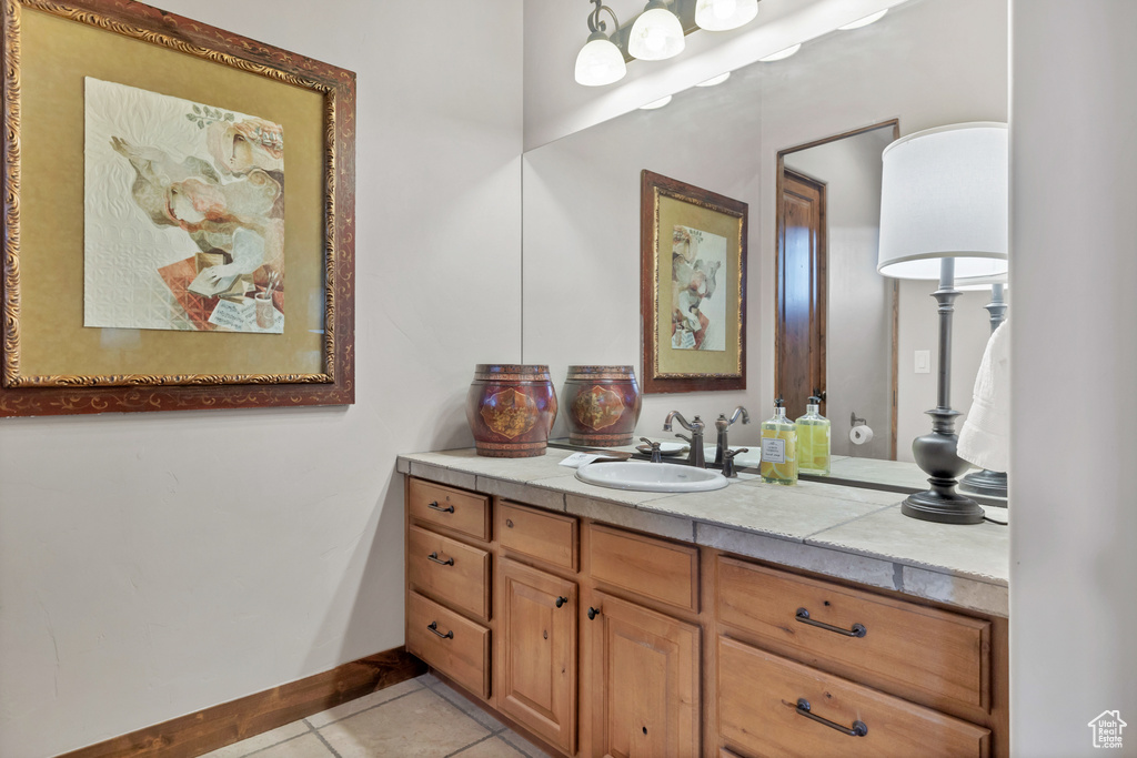 Bathroom with tile patterned flooring, baseboards, and vanity