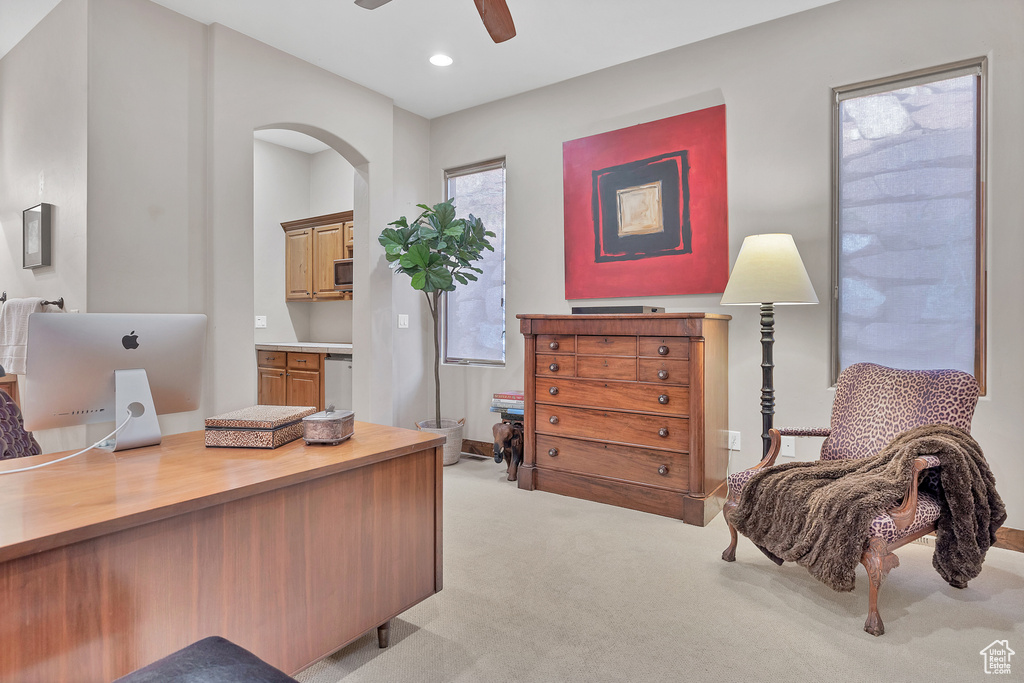 Office space featuring light carpet, arched walkways, a ceiling fan, and recessed lighting