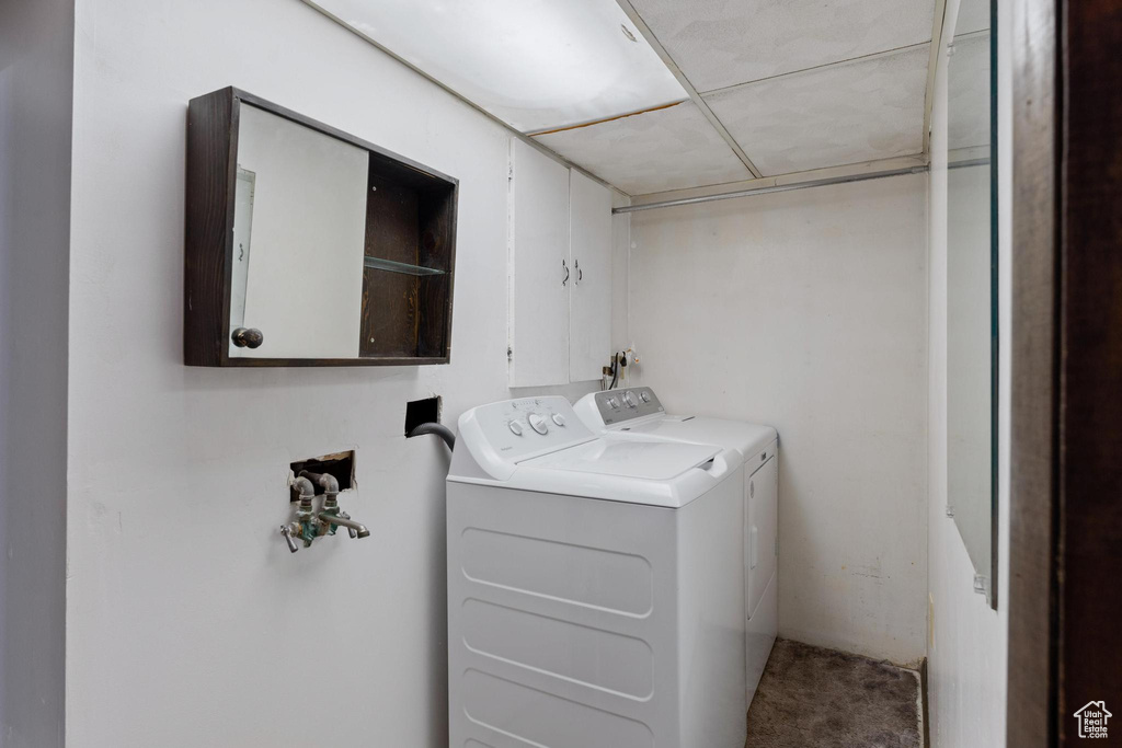 Laundry area with cabinet space, washer and clothes dryer, and carpet