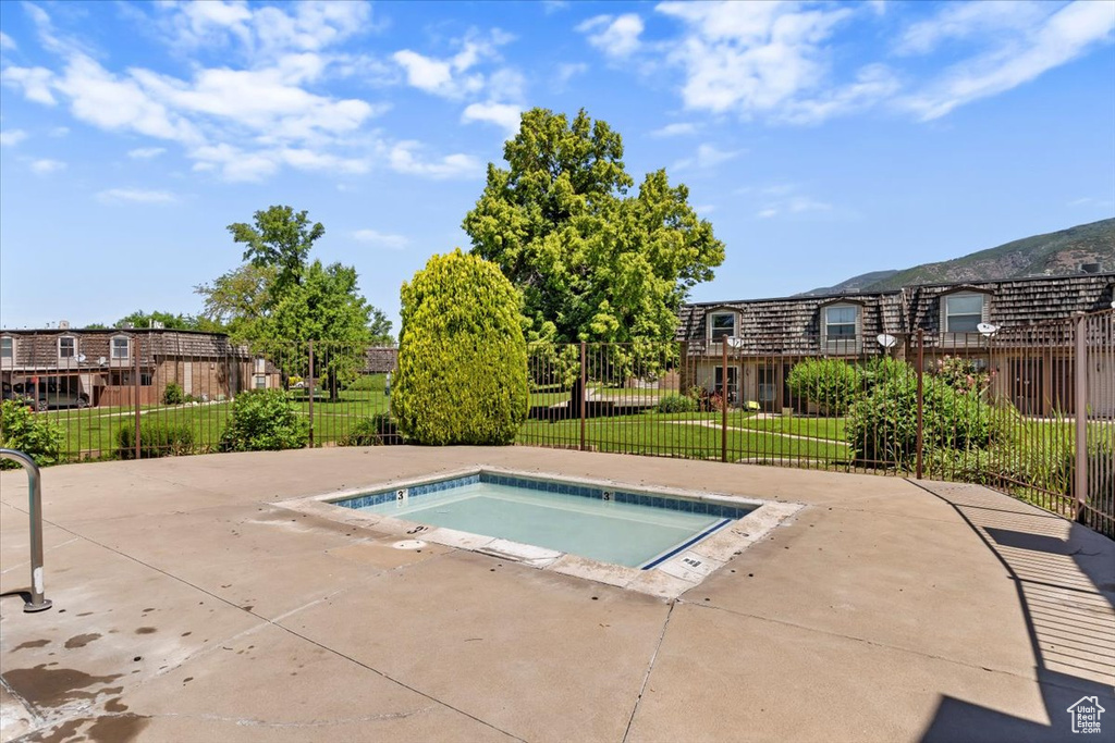 View of swimming pool with a hot tub