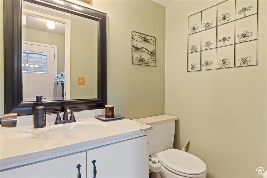 Half bath featuring vanity and toilet