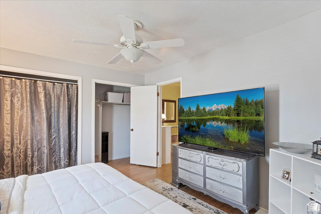 Bedroom with wood finished floors and a ceiling fan