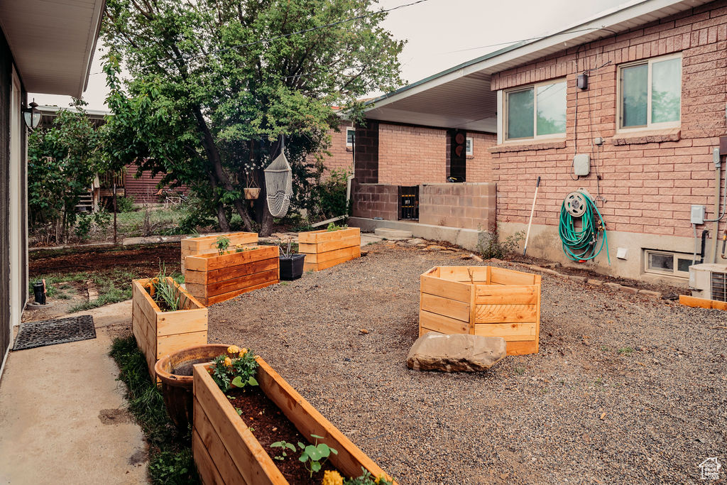 View of patio / terrace featuring a vegetable garden and central AC