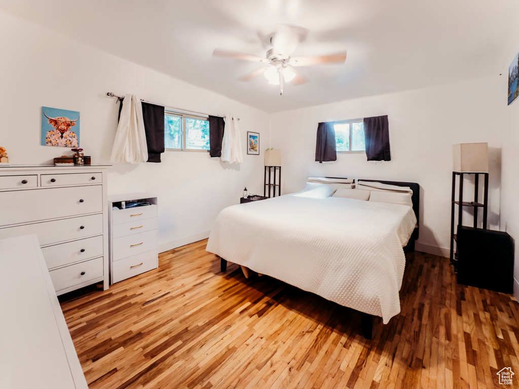 Bedroom featuring light wood-style flooring, ceiling fan, and baseboards