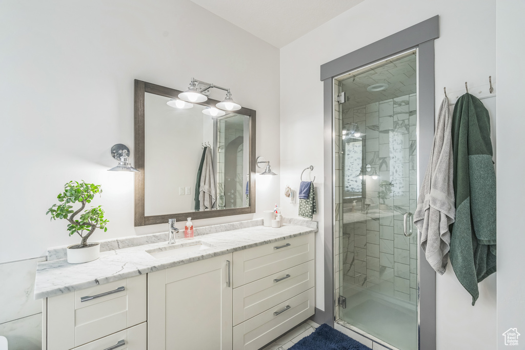 Full bath with vanity and a stall shower