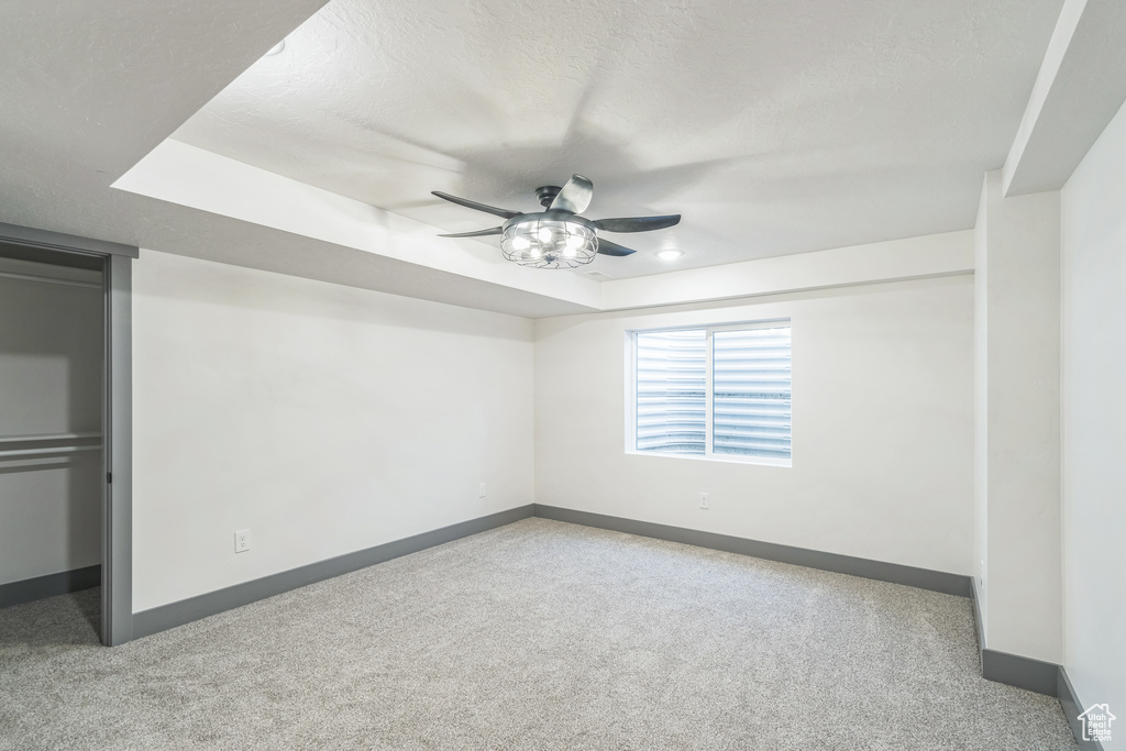 Unfurnished bedroom with baseboards, carpet, and ceiling fan