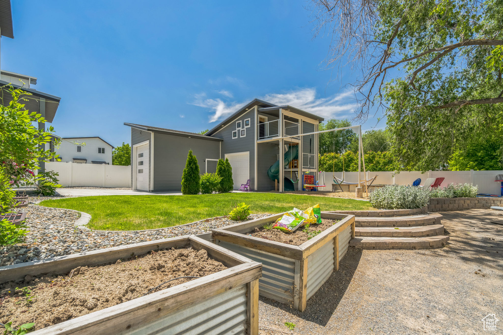 Rear view of property with a garden and an outbuilding