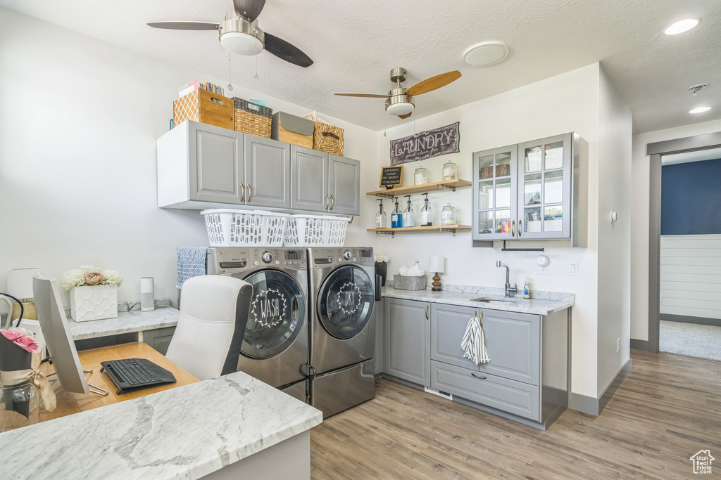 Laundry room featuring washer and dryer, cabinet space, a ceiling fan, light wood-style floors, and recessed lighting