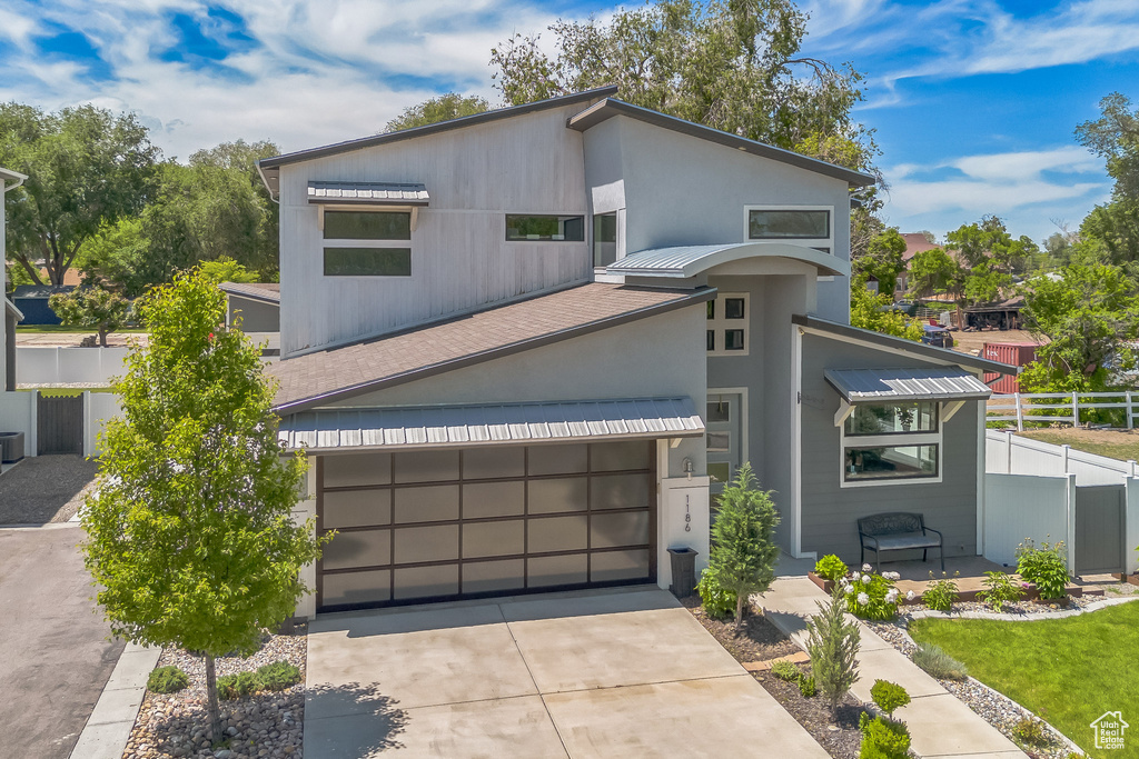 Modern home featuring driveway and stucco siding