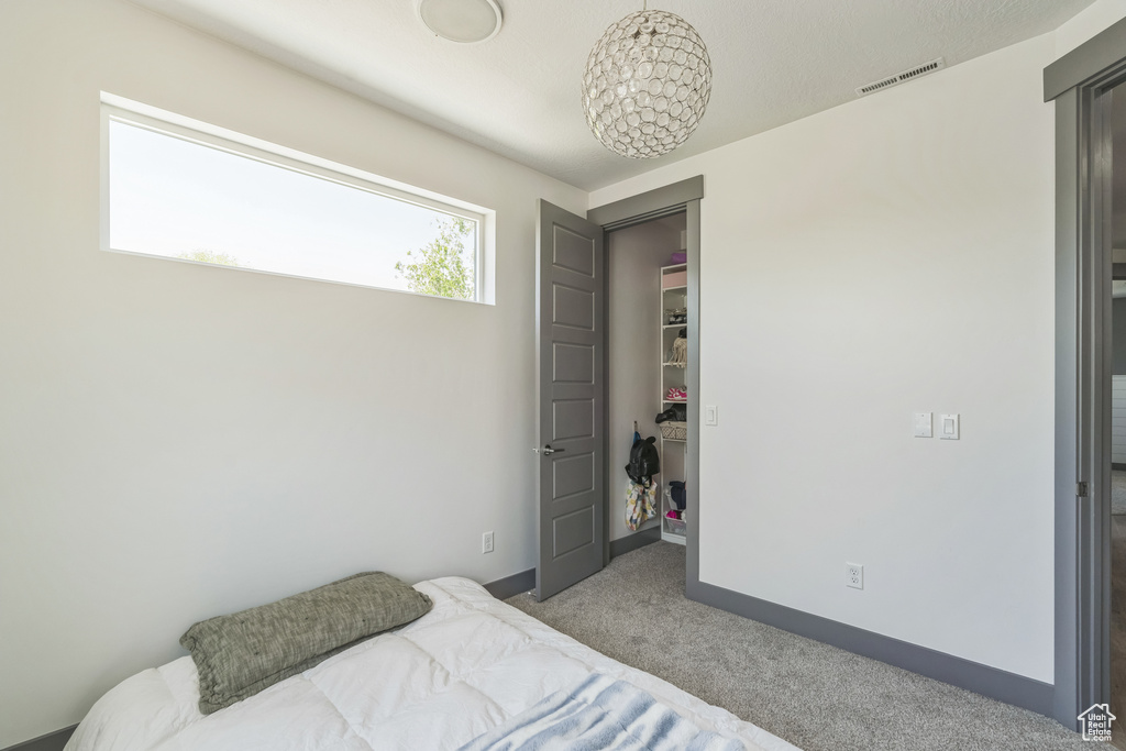 Bedroom featuring carpet and baseboards