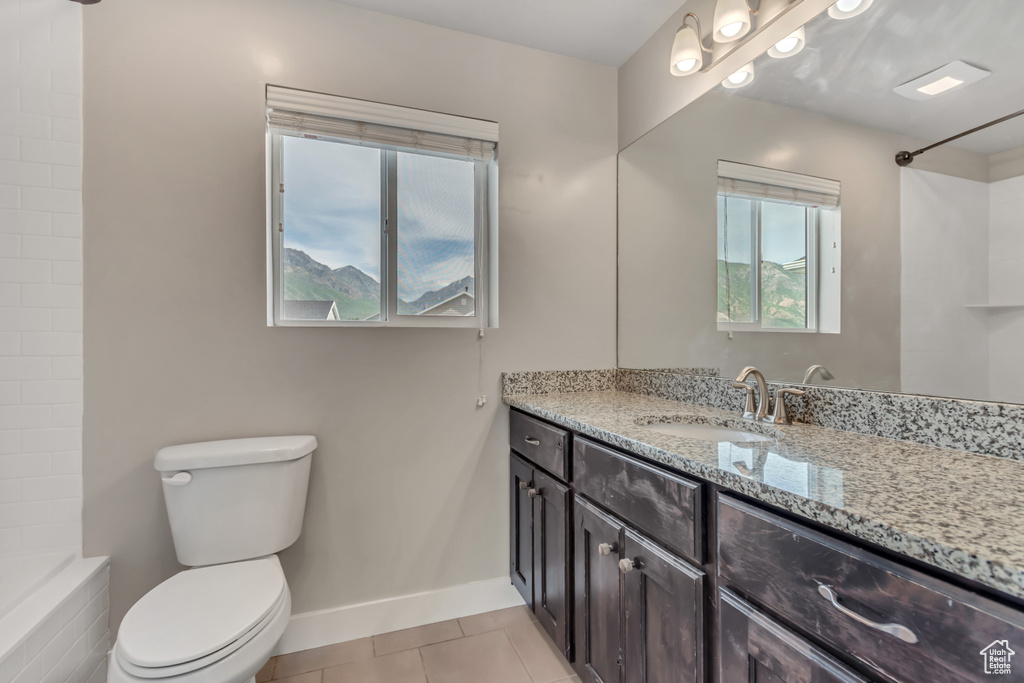 Full bathroom featuring vanity, toilet, tile patterned floors, and baseboards