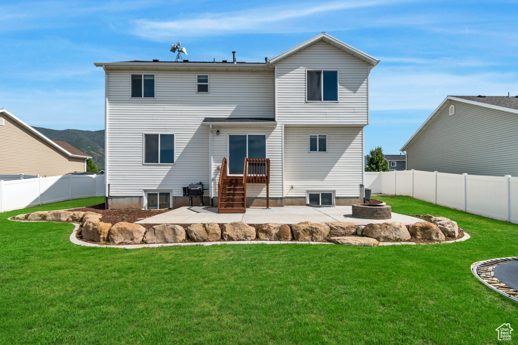 Rear view of property with an outdoor fire pit and a patio