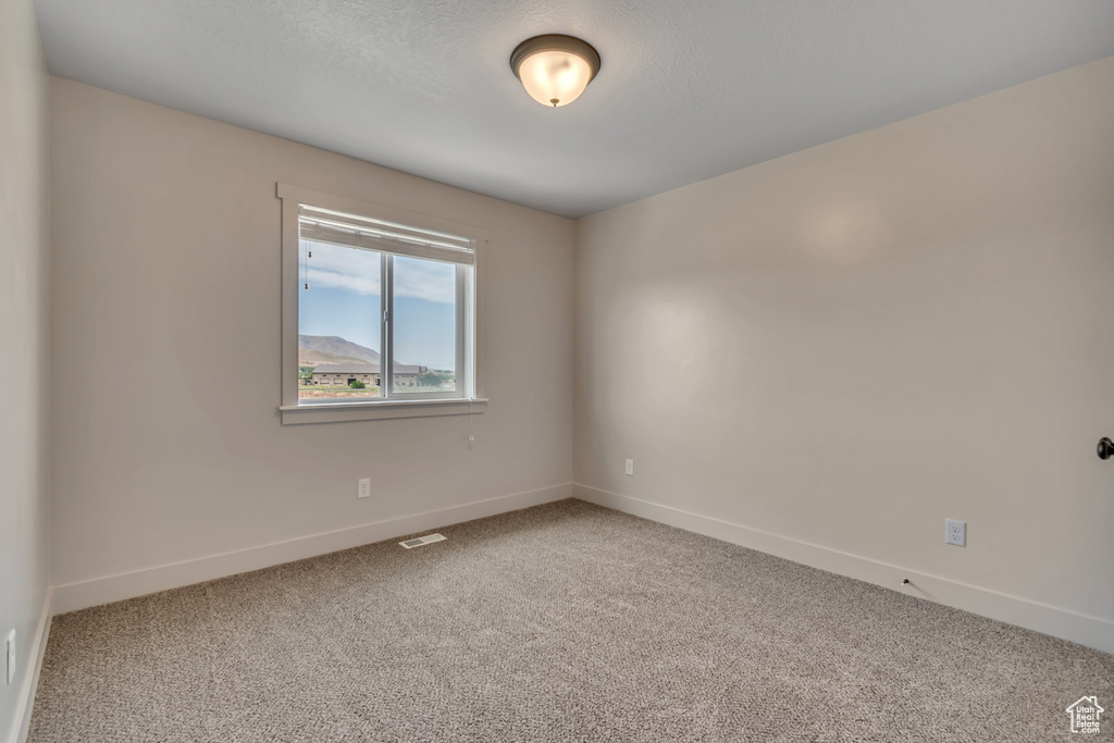 Spare room with carpet floors and baseboards