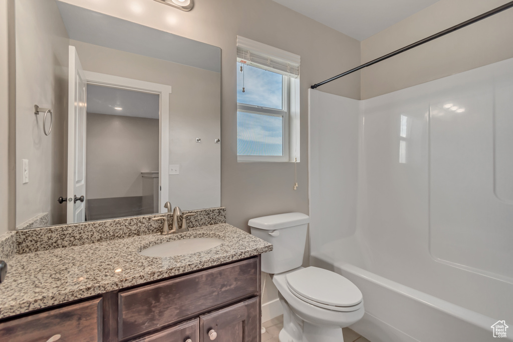 Full bath featuring vanity, toilet, and bathtub / shower combination