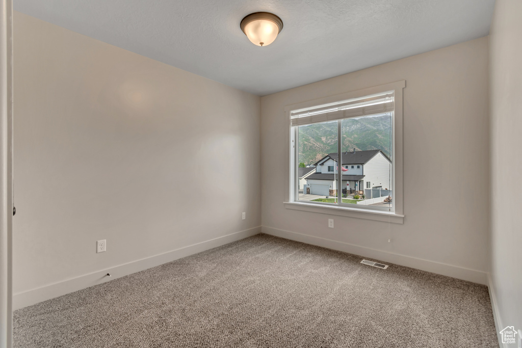 Unfurnished room with carpet flooring and baseboards