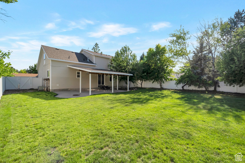 Back of property with a patio area and a gate