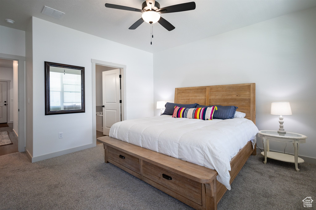 Carpeted bedroom featuring baseboards and ceiling fan