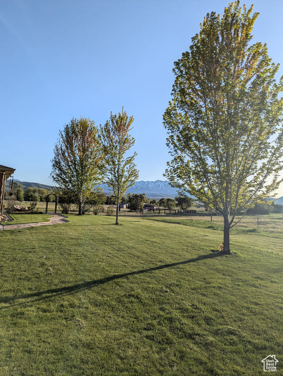 View of green lawn featuring a mountain view