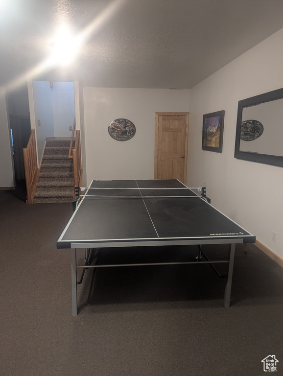 Game room featuring carpet floors and baseboards