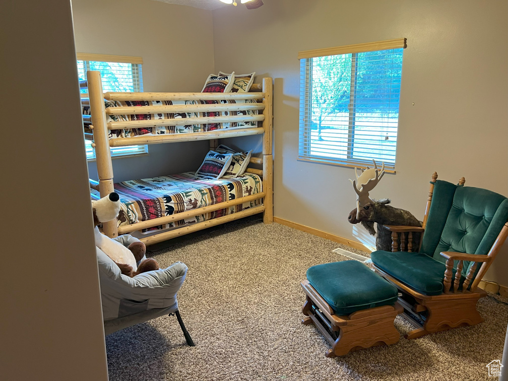 Carpeted bedroom featuring baseboards