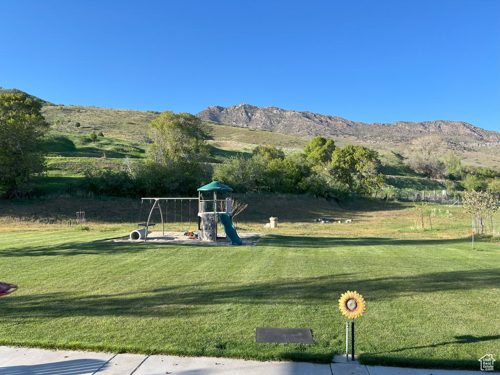 View of green lawn featuring a mountain view