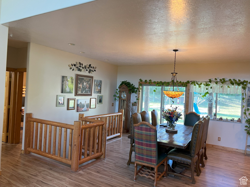 Dining area featuring wood finished floors and a textured ceiling