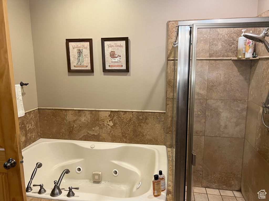 Full bath featuring a tub with jets and a shower stall