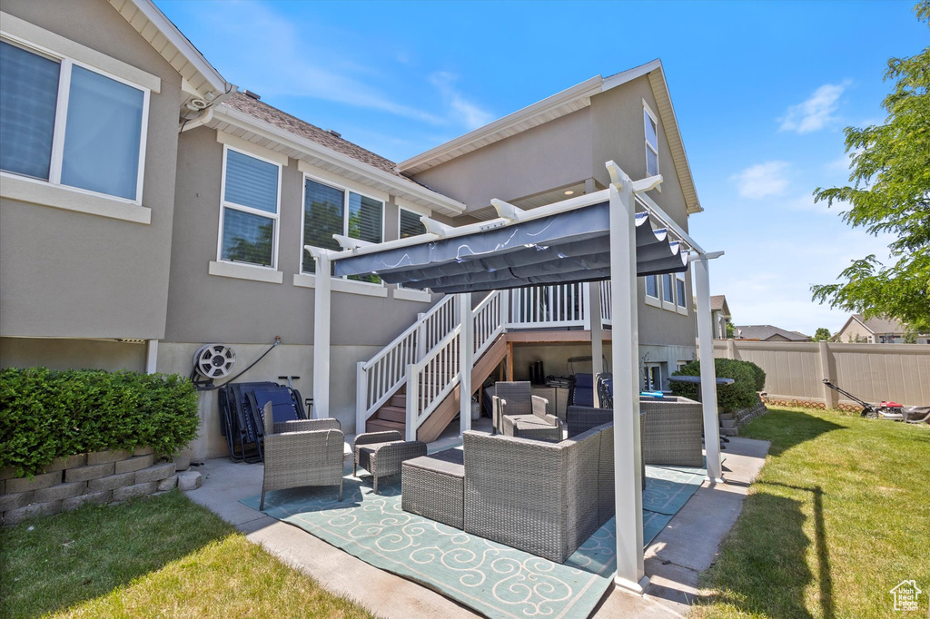 Rear view of house featuring an outdoor hangout area, a patio area, stucco siding, and stairs