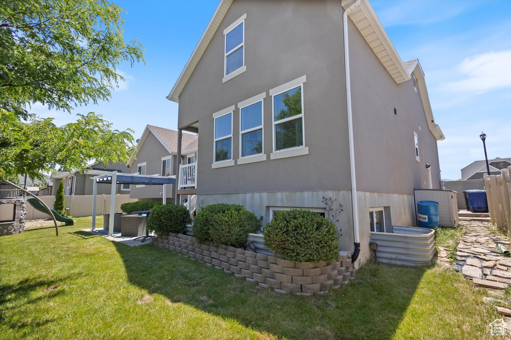 Rear view of property with stucco siding