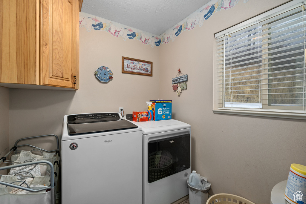Laundry room with cabinet space and washing machine and clothes dryer