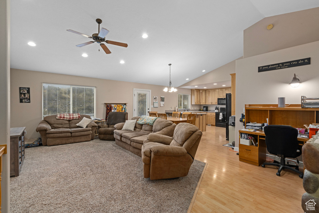 Living room featuring vaulted ceiling, light wood-style floors, an office area, recessed lighting, and a ceiling fan