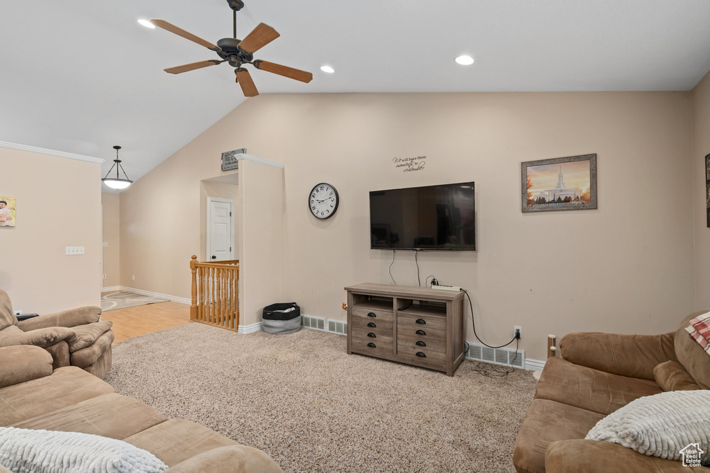 Living area featuring a ceiling fan, baseboards, lofted ceiling, recessed lighting, and carpet floors