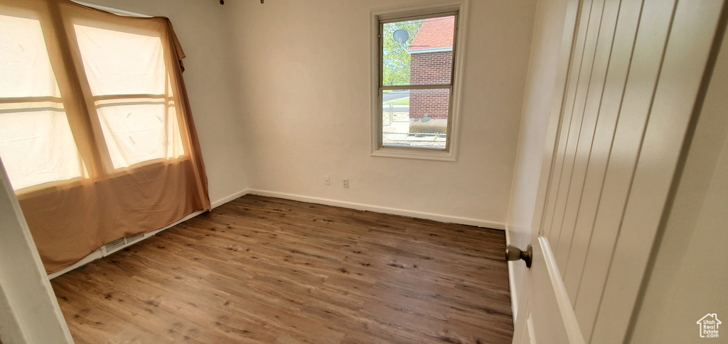 Spare room with wood finished floors and baseboards