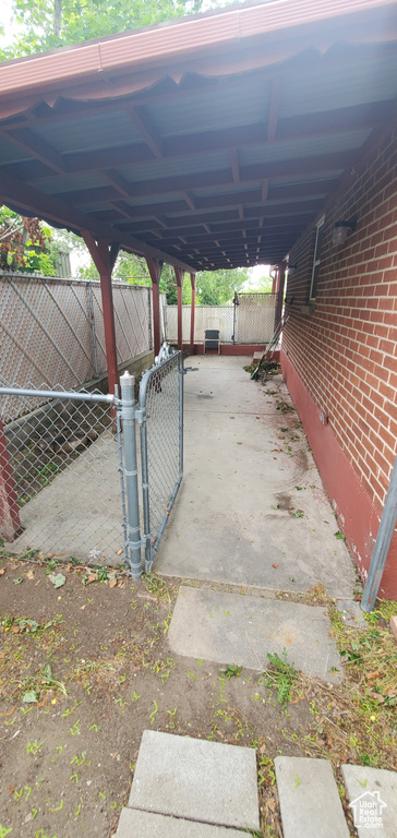 View of parking featuring a gate