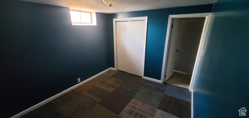 Unfurnished bedroom with a closet and baseboards