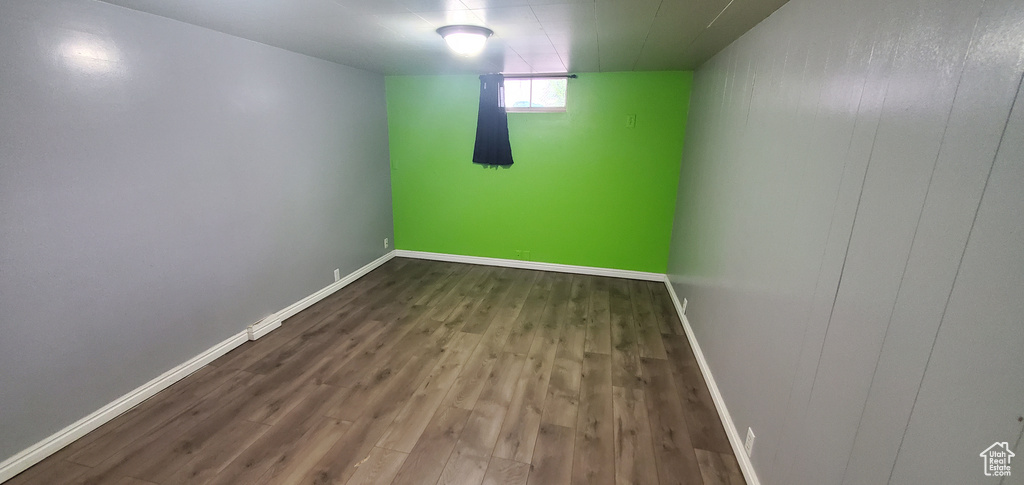 Below grade area featuring wood finished floors and baseboards