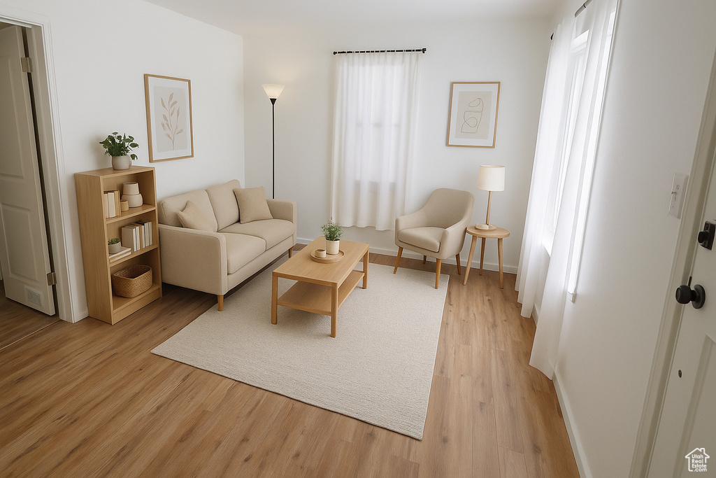 Living area featuring light wood-style floors and baseboards