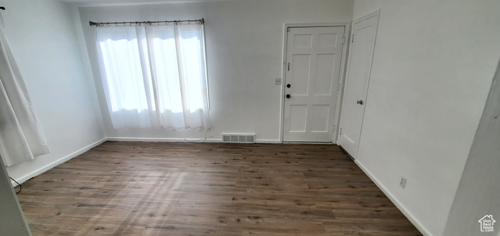 Foyer entrance featuring wood finished floors and baseboards
